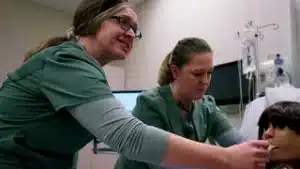 LPN students working in lab with a medical mannequin